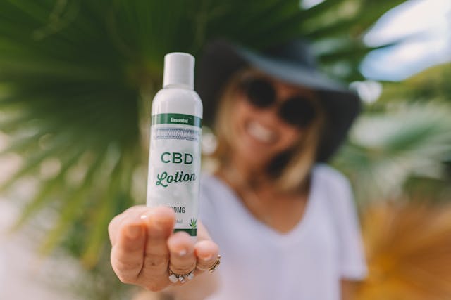 person holding a bottle of CBD oil